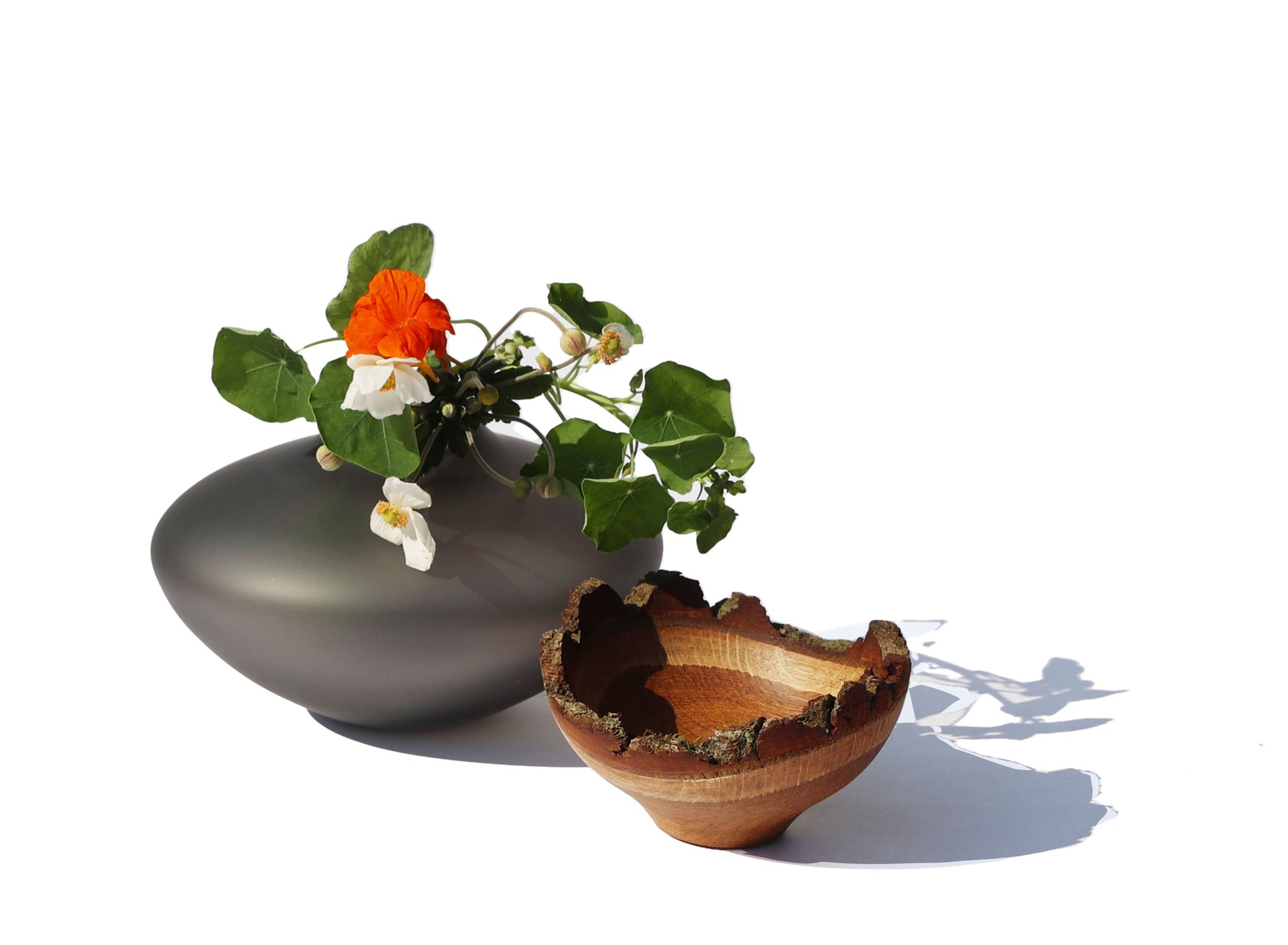 Bloom Stacking Vessel in Smoke Satin Unstacked with Flowers, showcasing a smooth, sophisticated design with a smoky finish and elegant stacking form.
