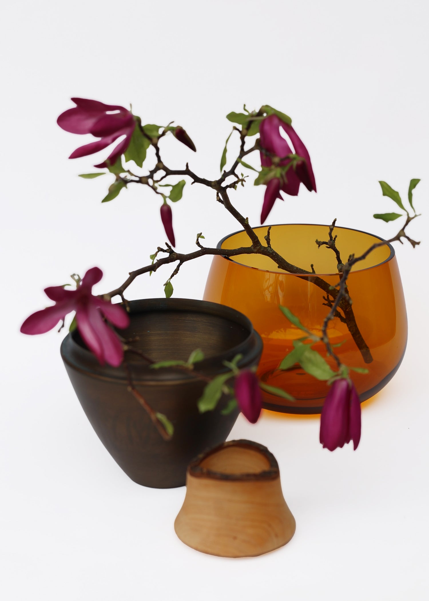 India I Stacking Vessel in Amber & Patina Unstacked with Flowers, merging the warm amber color with the elegance of brass for a timeless and refined design.