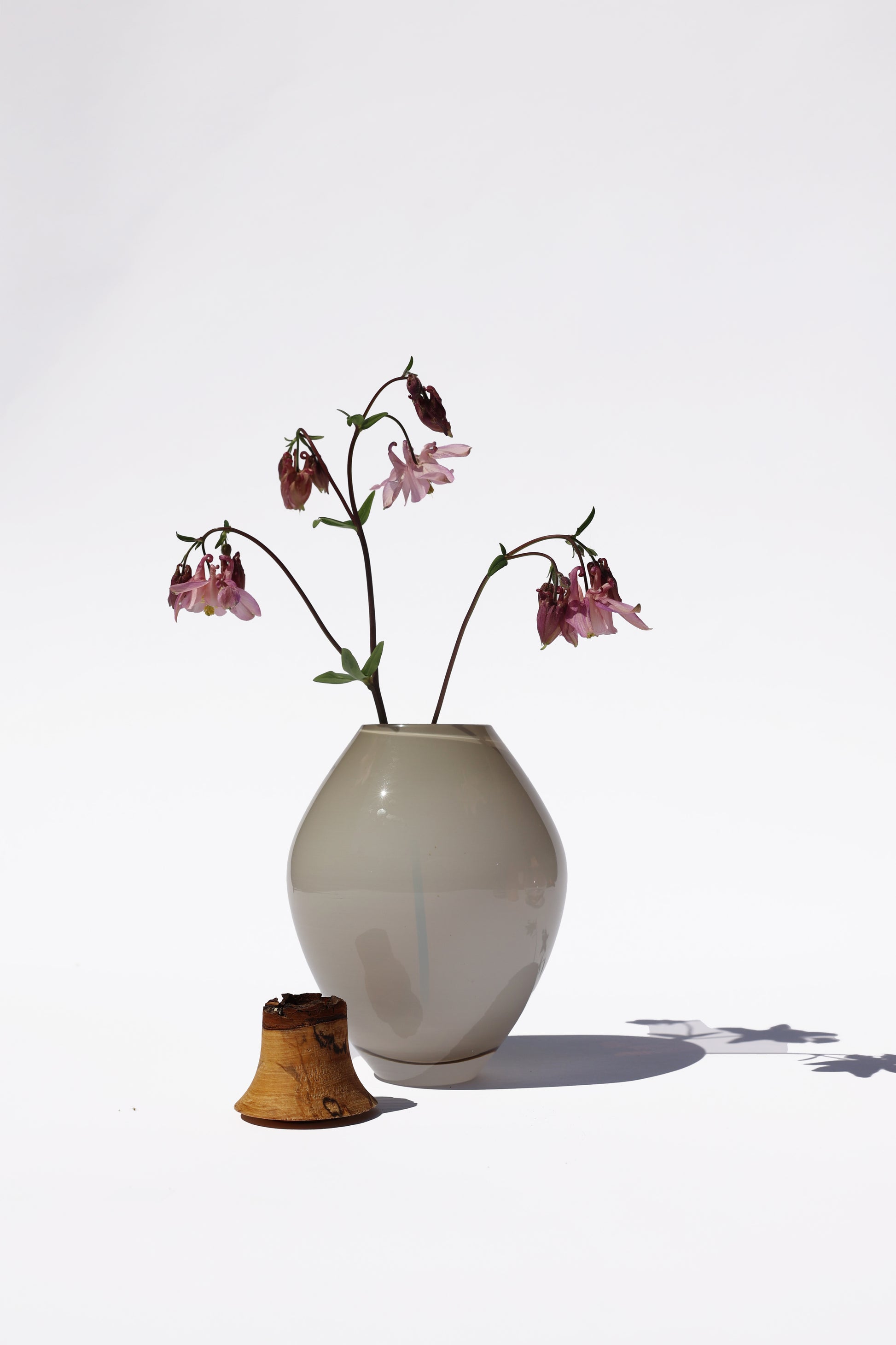 Matisse III Smoke Opalin Stacking Vessel unstacked, featuring a floral arrangement for a refined, modern look.