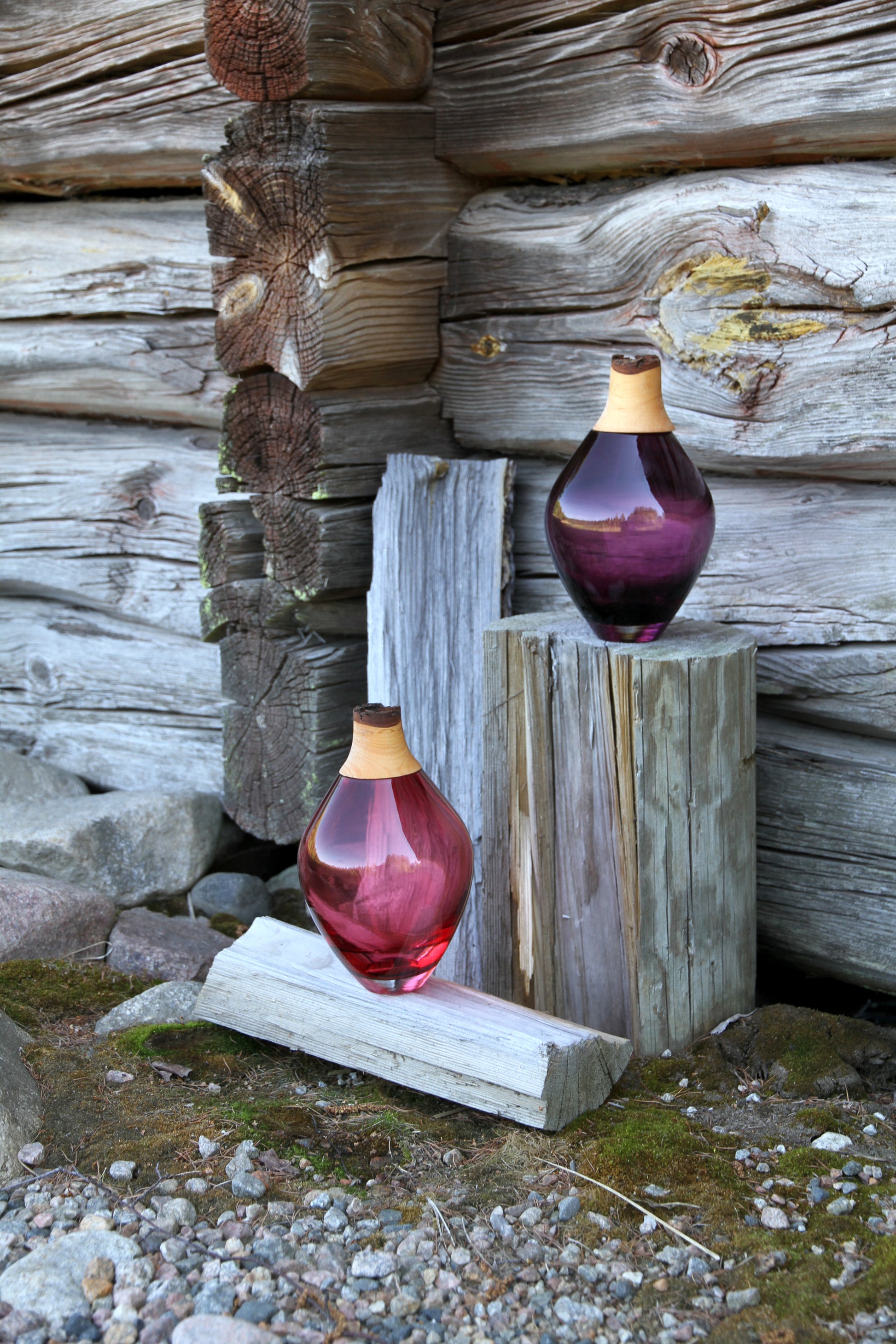 Matisse III Stacking Vessel, a contemporary design displayed in an outside setting on wood.