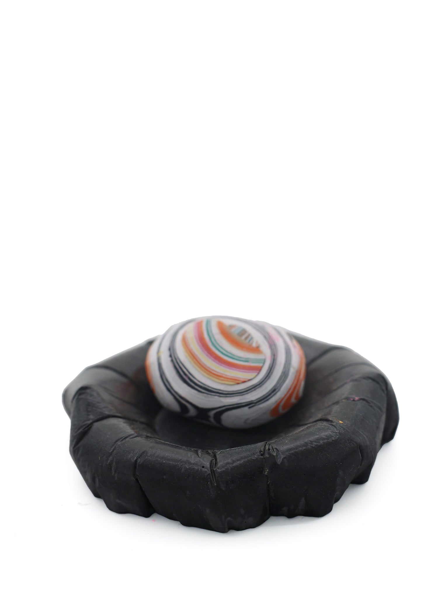 Paper Pebble in Black, showcasing a minimalist design with a smooth, dark finish, adding a contemporary touch to any space.