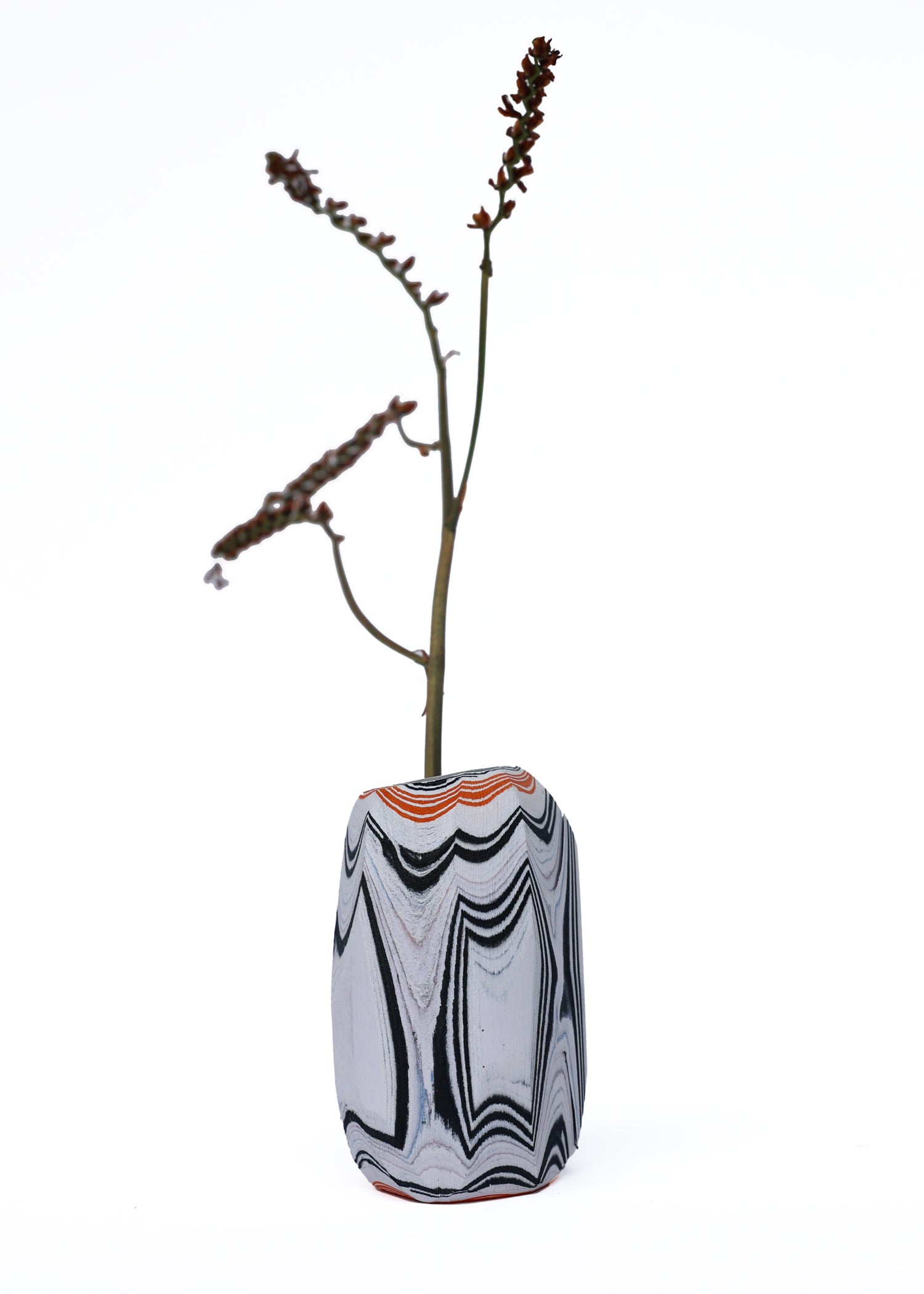 Paper Pebble Vase in Black & Orange with flower, featuring a bold contrast between deep black and vibrant orange, perfect for striking accent pieces.