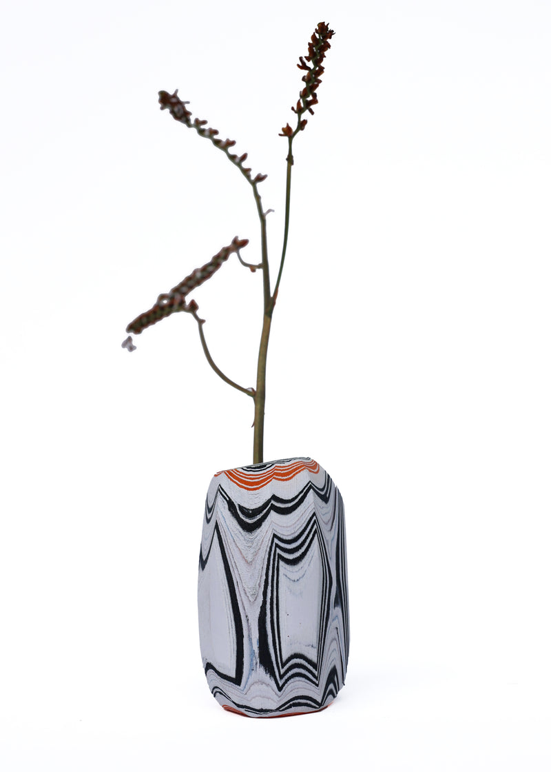 Paper Pebble Vase in Black & Orange with flower, featuring a bold contrast between deep black and vibrant orange, perfect for striking accent pieces.