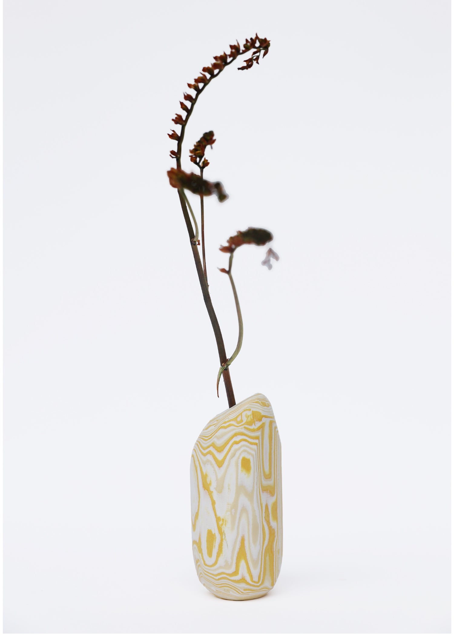 Paper Pebble Vase in Yellow & White with flower, combining bright yellow and crisp white for a fresh, modern look in home decor.