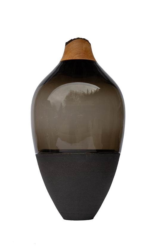 Transformed Stacking Vessel in Smoke, featuring a sleek, smoky glass composition with a sculptural stacked silhouette.
